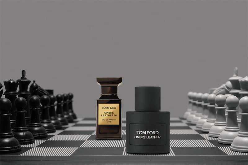 A Tom Ford Ombre Leather 16 bottle next to the new look Ombre Leather Signature bottle on a chess board.