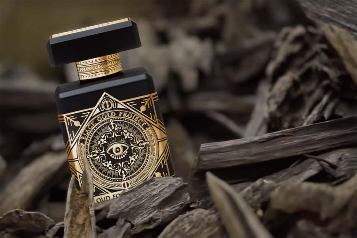 A bottle of Initio Parfums Prives Oud for Greatness amongst a pile of oud wood chips.