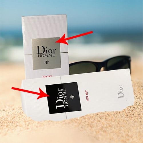 A packaging box of the previous formulation of Dior Homme Sport next to the packaging box of the new formulation of Dior Homme Sport, both partially buried in sand on the beach in front of a pair of sunglasses with the sea horizon in the background.