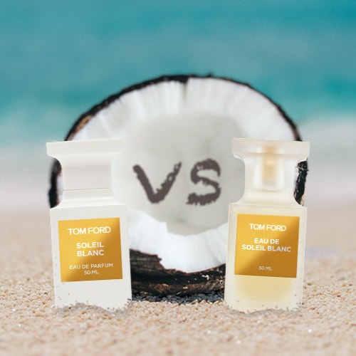 A bottle of Tom Ford Soleil Blanc Eau de Parfum beside a bottle of Tom Ford Eau de Soleil Blanc Eau de Toilette. Both bottles are partially buried in the sand on the beach, sitting directly in front of a fresh half-cut coconut shell with a sunny sea horizon in the background. Carved into the facing shell of the coconut is the word: vs.