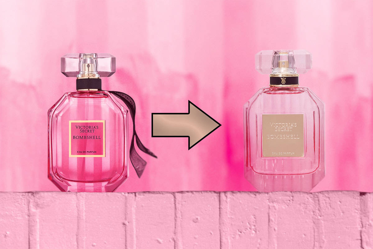 A close-up of the previous Victoria’s Secret Bombshell EDP bottle sitting right next to the new, updated bottle. The old bottle is on the left side, and the new bottle is on the right side. Both bottles are sitting on top of a light pink colored brick wall. In-between the bottles is an arrow that is pointing in the direction of the new bottle on the right.