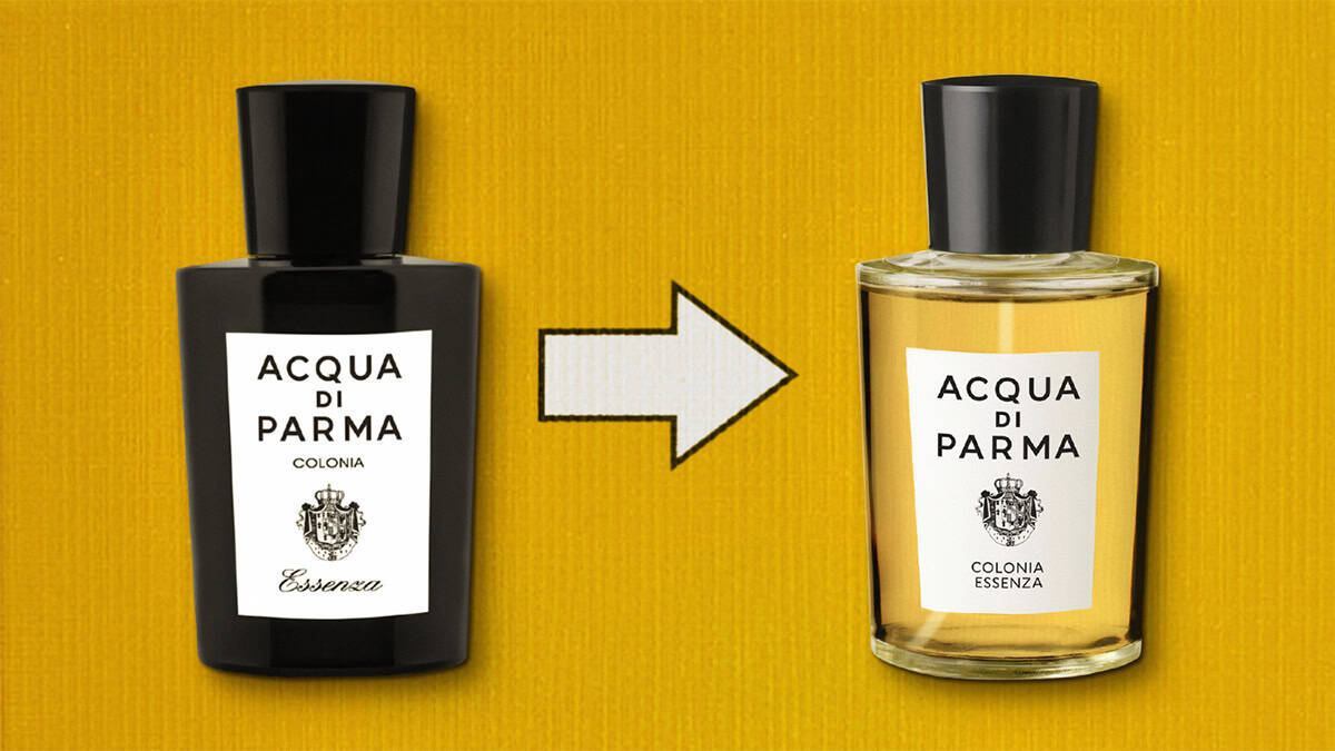 A close-up comparison of the front face of the first released all-black-colored glass bottle of Acqua Di Parma Colonia Essenza, which has a white-colored label. To the right of this bottle is the updated transparent-glass bottle of Acqua Di Parma Colonia Essenza that has a white-colored label and a black-colored cap. The 2 bottles are placed on their side next to each other, label side up, and are resting on a yellow-colored textured surface. Between the 2 bottles is a white arrow printed on the background surface pointing towards the updated transparent-glass bottle on the right.